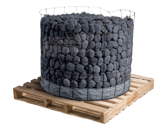Dark grey natural stone cobbles in a wire basket on a wooden pallet