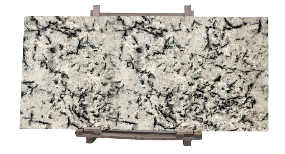 White and black patterned natural stone slab displayed on a wooden stand