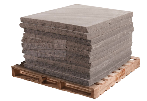 Brownstone natural stone pillar caps stacked on a wooden pallet for outdoor columns