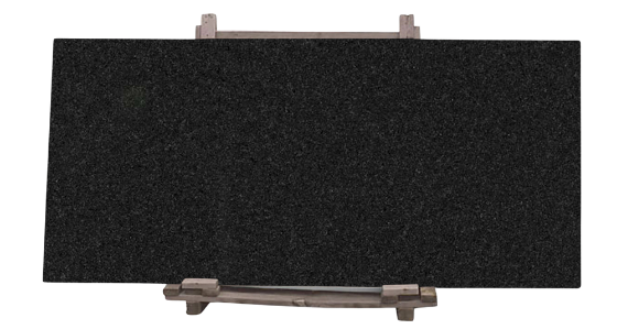 Premium black granite natural stone slab on a wooden pallet