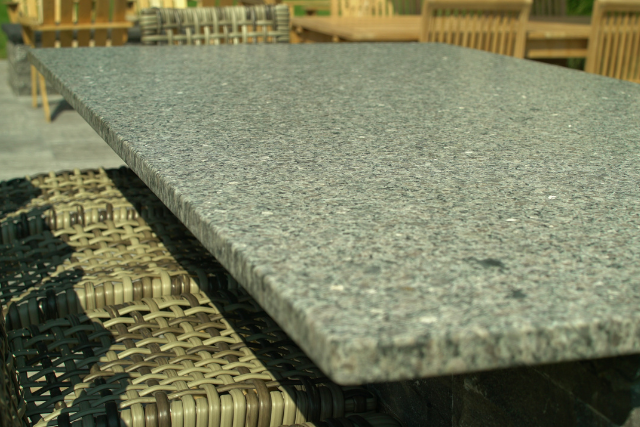 Natural stone slab outdoor dining table with speckled grey surface
