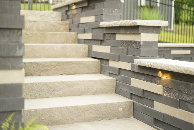 Natural stone steps with stacked stone wall sides and inset lighting
