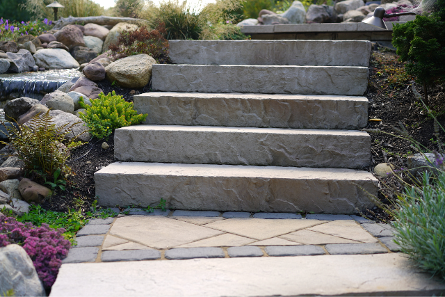 Natural stone steps with boulders, waterfall, and garden landscaping