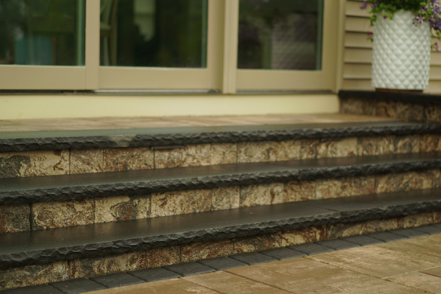 Natural stone treads with textured risers at a residential home entrance
