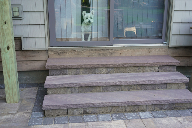 Natural stone treads on an outdoor staircase leading to a residential home entry