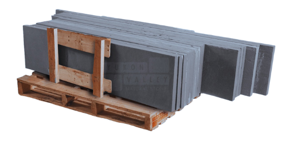 True Blue thermaled natural stone treads stacked on a wooden pallet