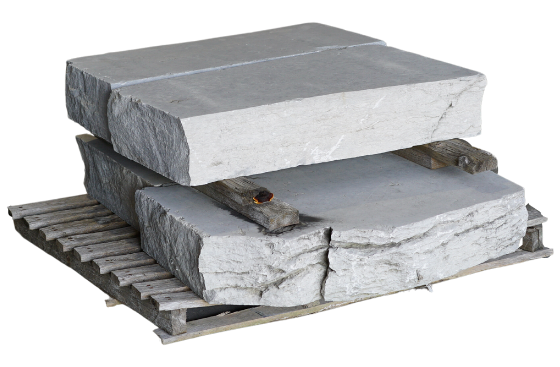 Weathered limestone natural stone steps stacked on a wooden pallet for outdoor landscaping